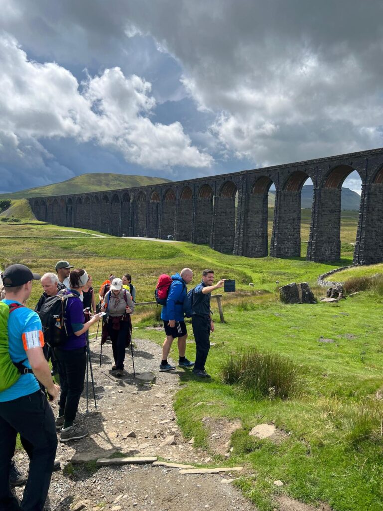 Walkers pictured at the Yorkshire 3 Peaks Challenge, in front of a Viaduct